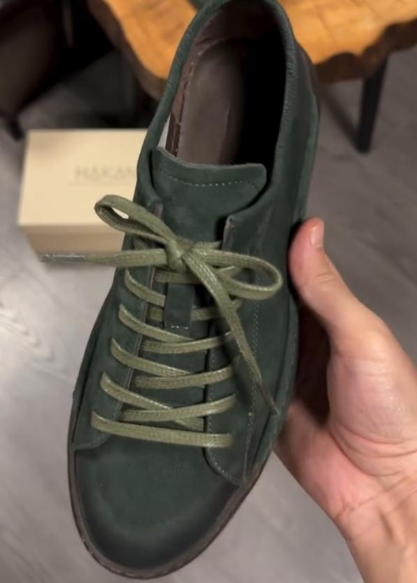 Green suede shoes with brown soles