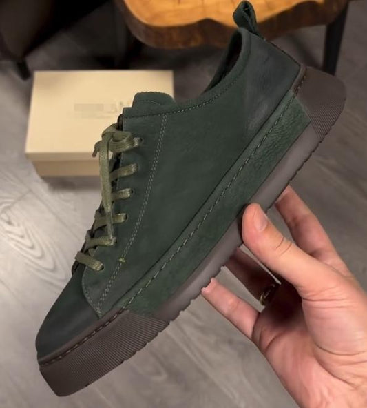 Green suede shoes with brown soles